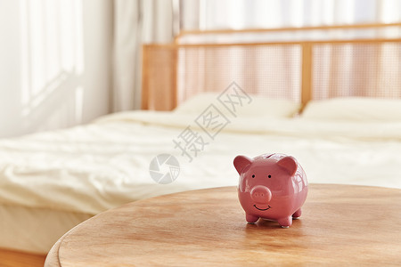 书桌茶几卧室桌上的小猪存钱罐背景