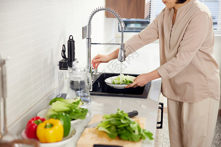 家庭主妇厨房洗菜形象背景图片