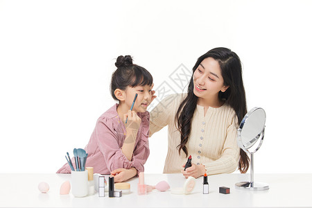 儿童化妆母亲教女儿使用化妆品背景