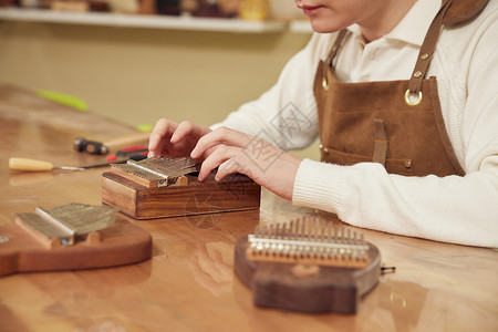 卡林努男性工匠手工制作拇指琴特写背景