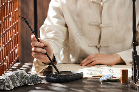 钢笔练字中国风书法用毛笔蘸墨特写背景