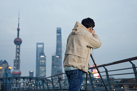 拍摄城市夜景的男摄影师图片