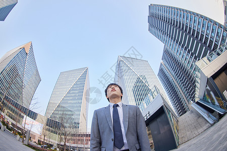 仰望城市的商务男青年背景图片