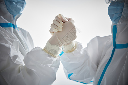 核酸提取穿防护服的医护人员握手特写背景