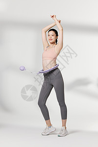 健身女性使用便携呼啦圈瘦身器材图片