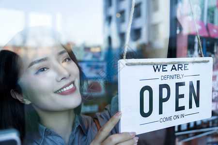 商店售货员咖啡店的女服务员挂营业标志背景