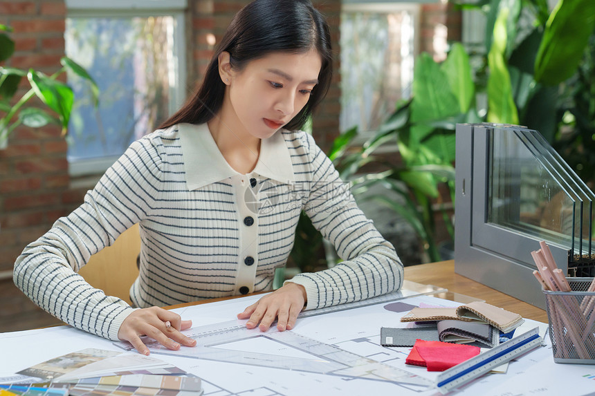 青年女设计师在办公室工作图片