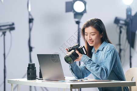 电子工艺在工作室里的青年女摄影师背景