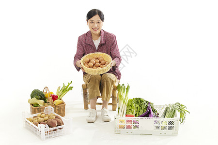 中年女性摆摊卖菜背景图片