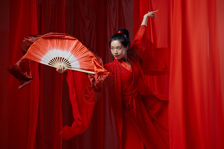 古风素材红印古典汉服女子跳惊鸿扇子舞背景