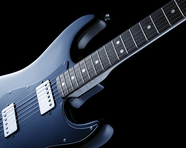 在蓝色的老式电吉他背景图片