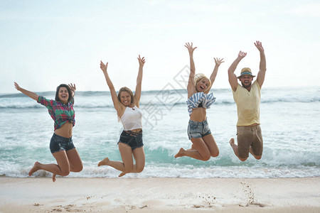 海滩上快乐跳跃的人图片