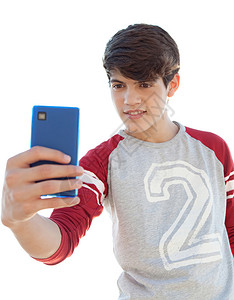 一个有吸引力的少年男孩用手拿着他的智能手机图片