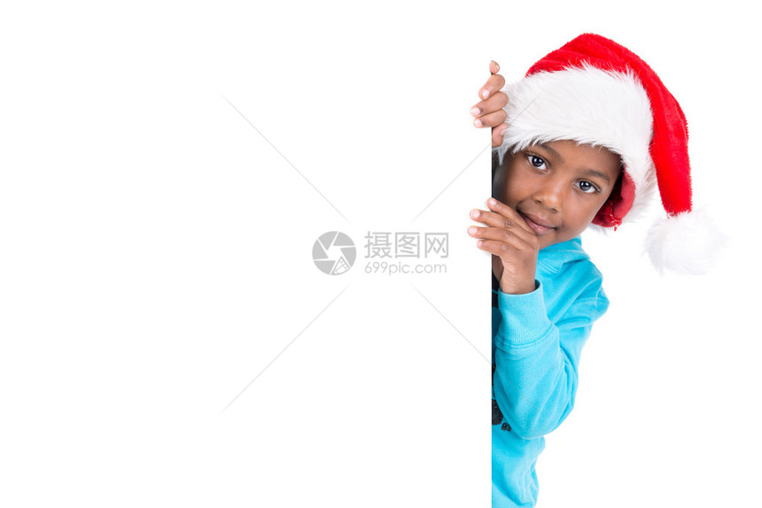 在圣诞老人帽子上的年轻男孩肖像白图片
