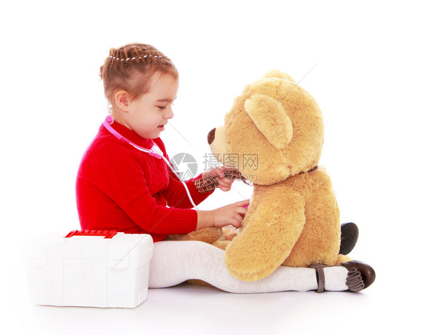在医院里跟泰迪熊玩的小女孩白图片