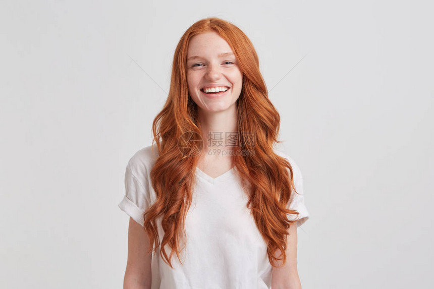 长的卷发和雀斑穿着时装T衬衫的漂亮可爱红发年轻女人的肖像图片