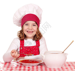 快乐的小女孩厨师吃汤图片