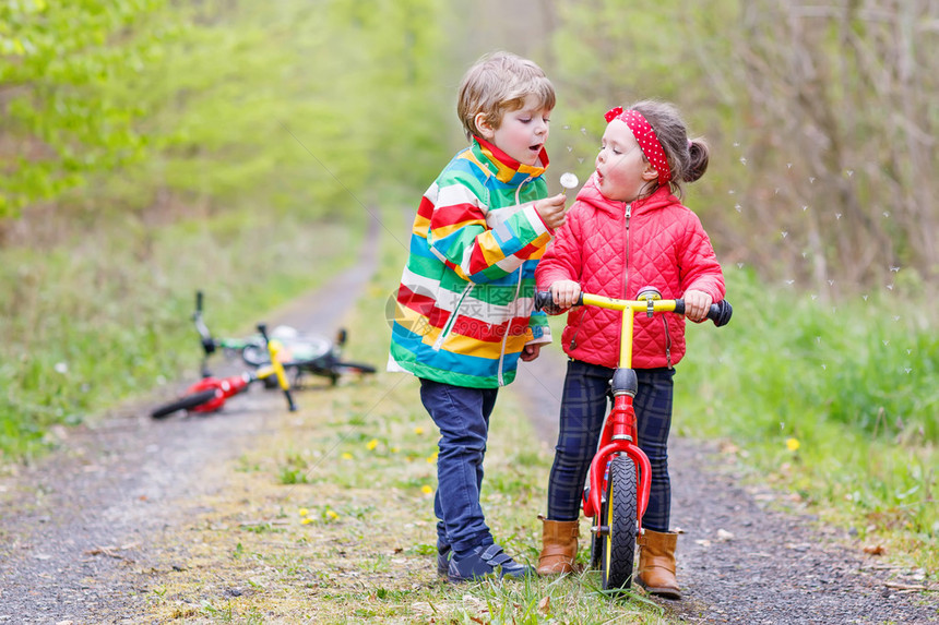 女孩和男孩子在雨天骑着自行车图片