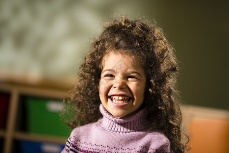 3岁快乐的三岁卷头发在幼儿园微图片