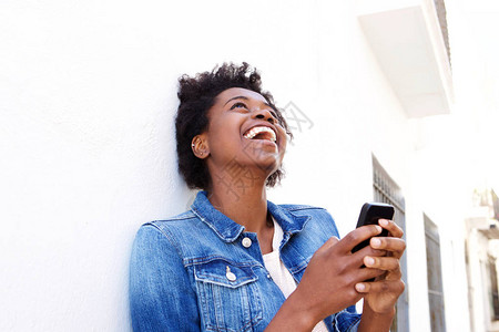 看着手机里的内容笑的很开心的黑人女子图片