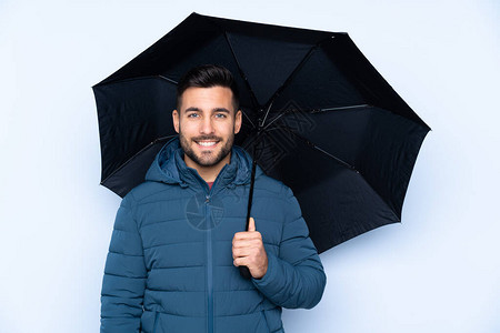 一个人拿着雨伞在孤立的背图片