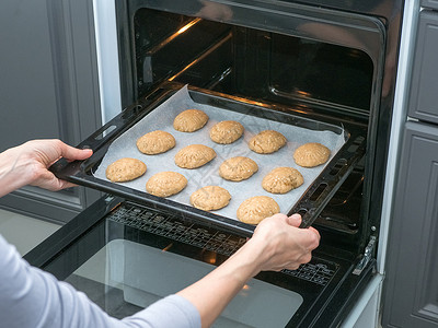 厨师在厨房的烤箱里烤饼干在烤箱里烤脆饼干手工图片