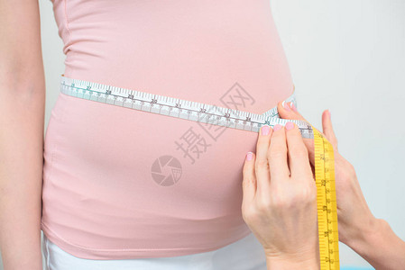 使用测量胶带测量孕妇腹部大小的妇产科妇医生拍图片