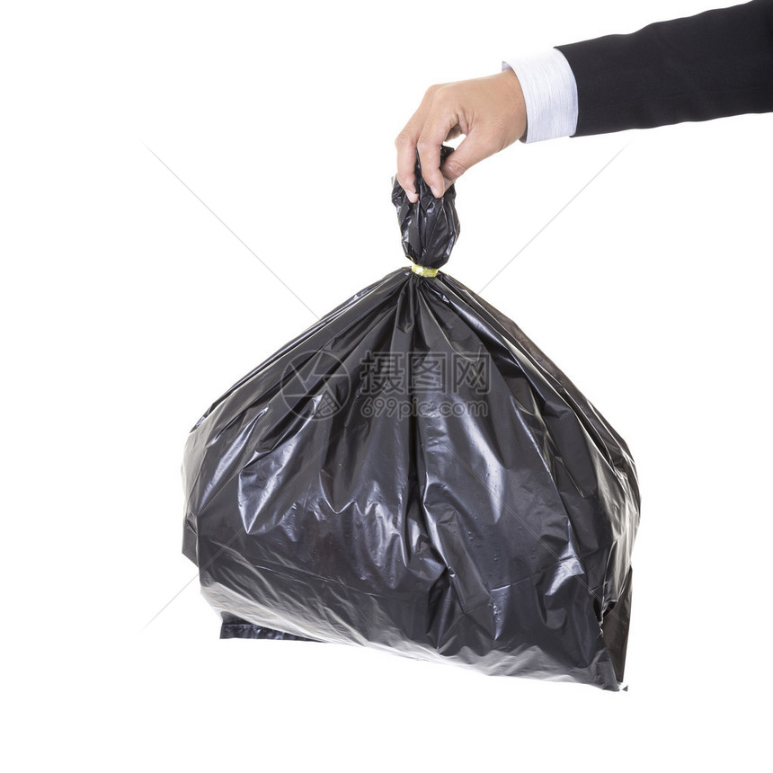 一个商人手握着一袋垃圾的黑袋子图片