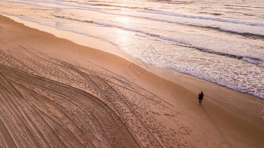 孤独的女人站在空旷的沙滩上图片