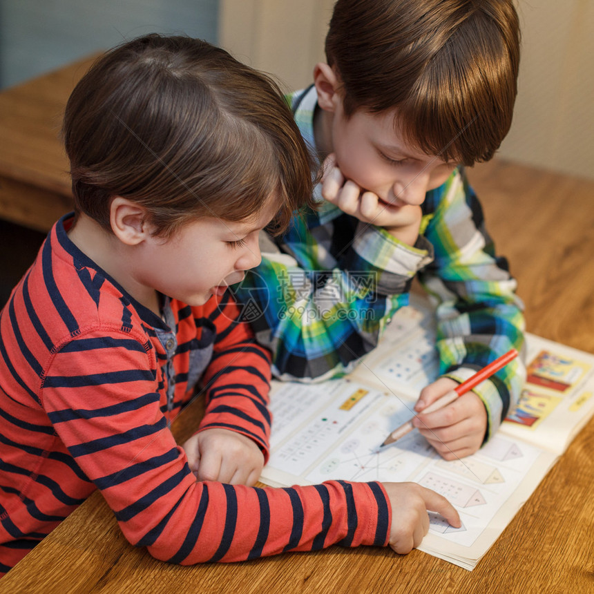 小天才男孩帮助他的兄弟完成家庭作业解图片