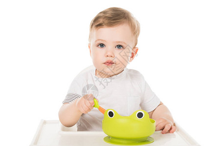 可爱的小可爱男孩吃盘子的青蛙形式图片