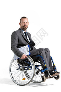 手持轮椅的有肢体残疾的商人图片