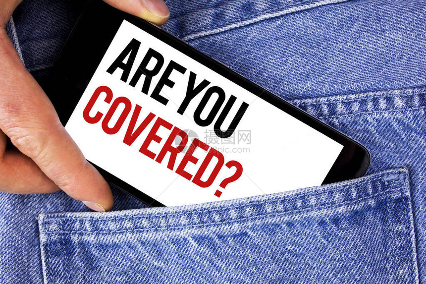 显示您是否被覆盖的问题的文本符号概念照片健康保险覆盖灾难恢复书面手机由蓝色牛仔裤图片