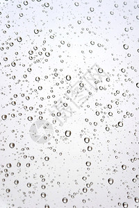 倾斜的窗户玻璃上的雨滴浅景深图片