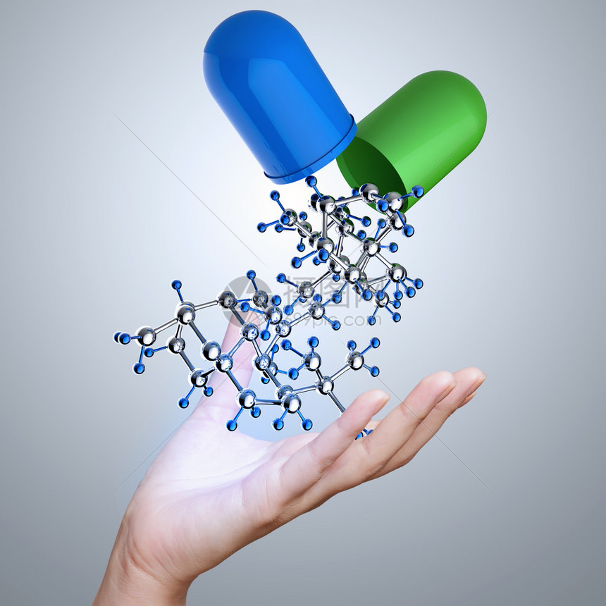 以胶囊丸和分子为医学概念的手图片