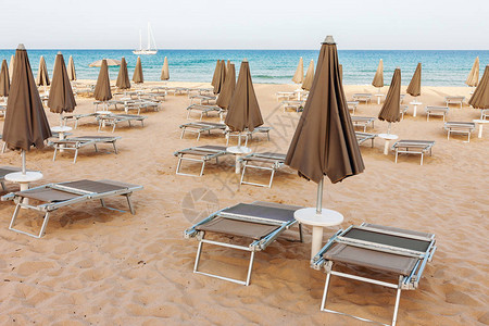 空海滩休闲游客和封闭的伞形阳伞图片