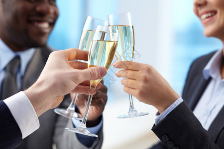 商业伙伴亲近手握着金香槟的背景图片