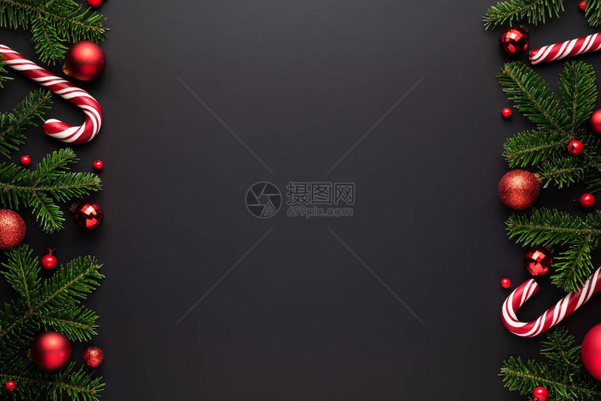 黑色圣诞节背景Fir树枝红圣诞球和糖果甘蔗图片