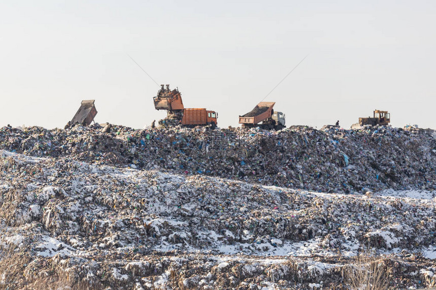 垃圾倾弃卡车在大片填埋场上卸垃圾图片