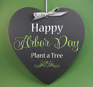 快乐Arbor日植树在绿色背景的心形背景图片