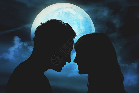一对年轻夫妇的剪影在月光下的天空下图片