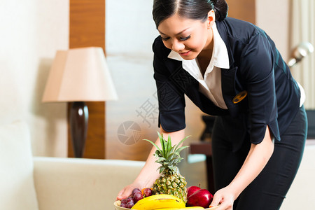 亚裔酒店管家为欢迎贵宾提供水果治疗的亚洲华图片
