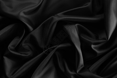 波纹黑丝织物的特写背景图片