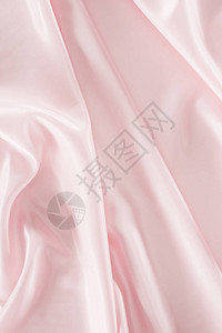 浅粉色闪亮缎面织物背景图片