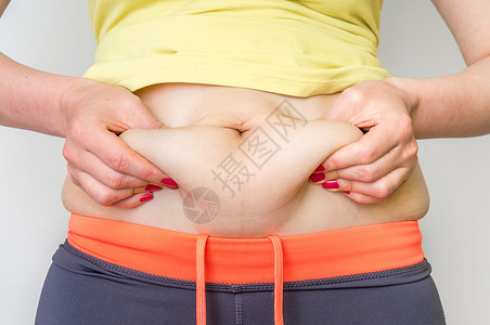 体重超双手触摸肚子脂肪的妇女身体图片