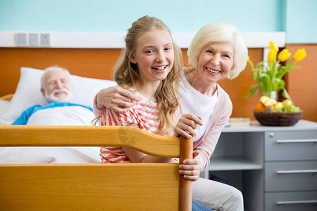 快乐的祖母和孙女在医院探视病人的肖像图片