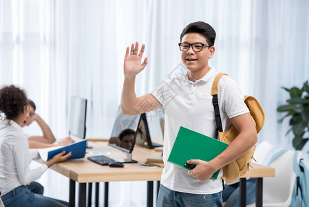 年轻的年青学生男孩与朋友在图片