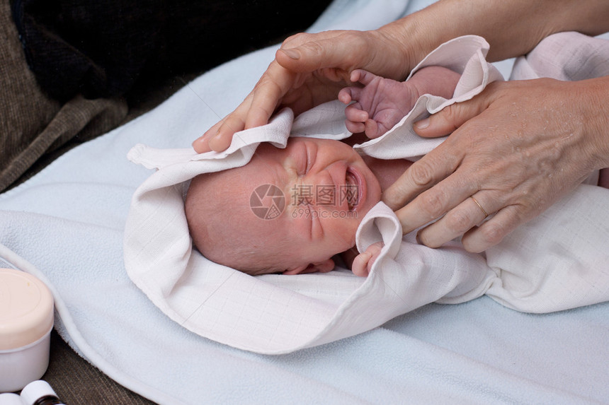 刚出生的女婴洗澡后哭泣图片