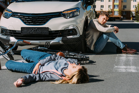 在汽车司机身后发生车祸后躺在路上的受伤妇女有选择地被图片