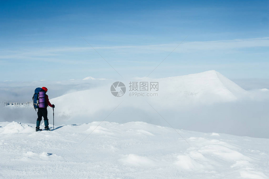 登山者欣赏雪山的图片